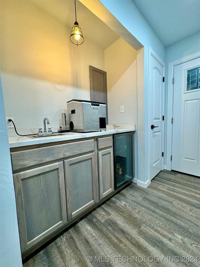 kitchen with dark hardwood / wood-style flooring, hanging light fixtures, and sink