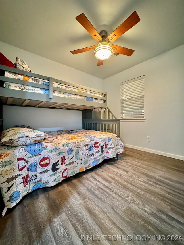 bedroom with ceiling fan and dark hardwood / wood-style flooring