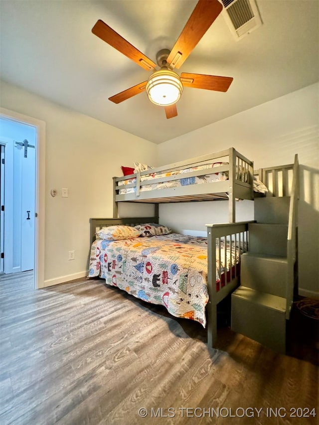 bedroom with hardwood / wood-style flooring and ceiling fan