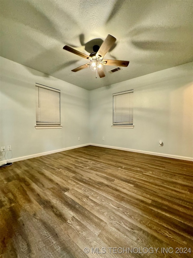 unfurnished room featuring a textured ceiling, ceiling fan, and hardwood / wood-style floors