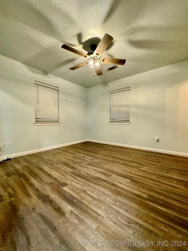 114399 Oak Rd, Eufaula, OK 74432 - spare room featuring wood finished floors, baseboards, visible vents, ceiling fan, and a textured ceiling