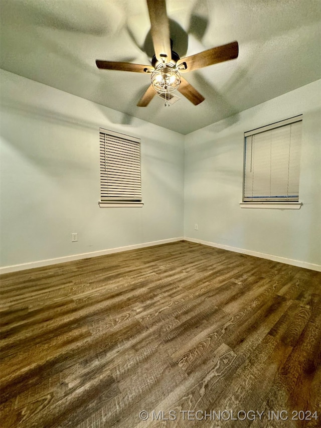 unfurnished room with ceiling fan and dark hardwood / wood-style floors