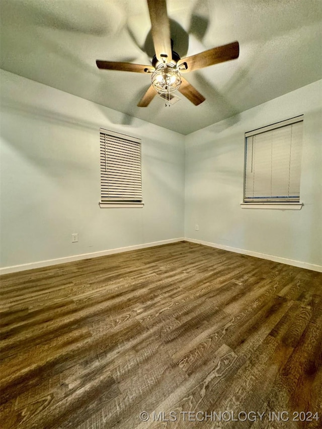 114399 Oak Rd, Eufaula, OK 74432 - unfurnished room featuring ceiling fan, baseboards, and dark wood finished floors