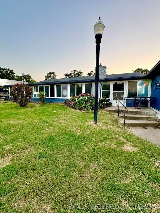 exterior space with a patio area and a yard