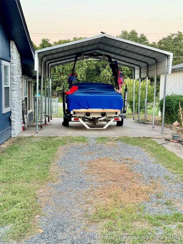 parking at dusk featuring a carport