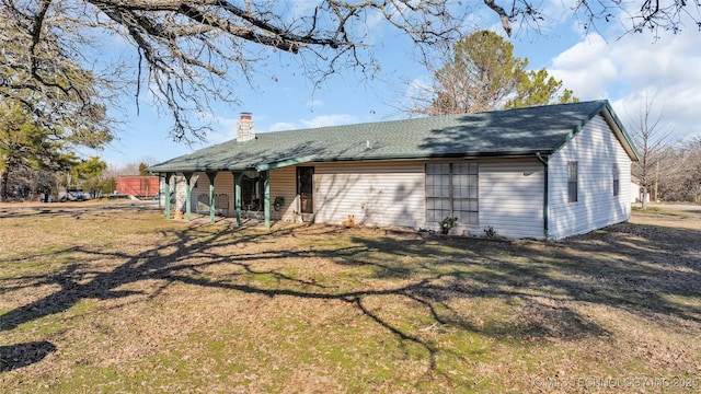back of property with a lawn