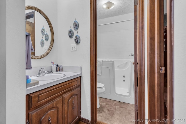 bathroom with a washtub, a textured ceiling, toilet, and vanity