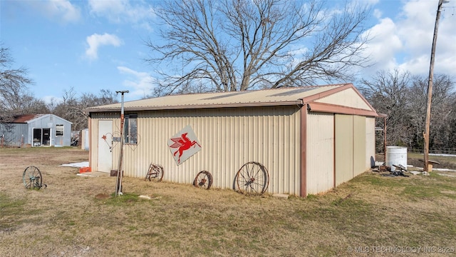 view of outbuilding with a yard