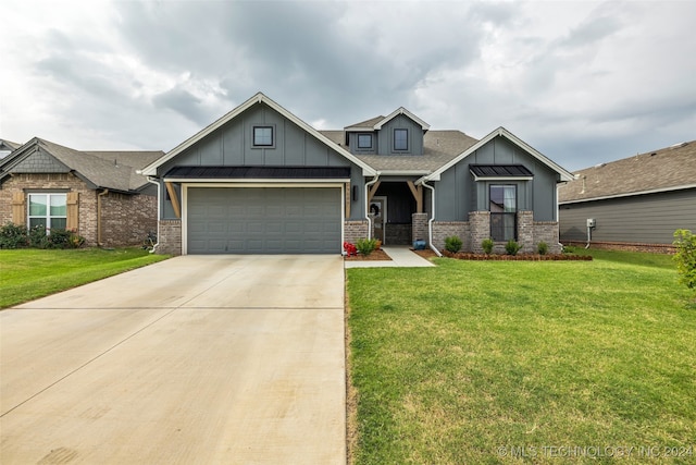 craftsman inspired home featuring a garage and a front lawn