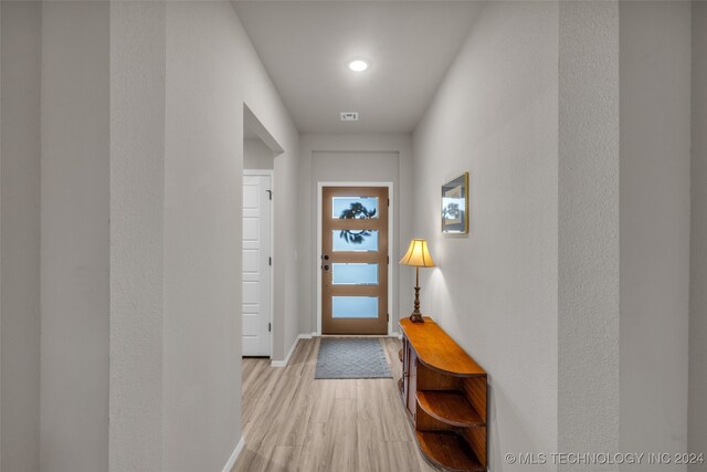 doorway to outside featuring light hardwood / wood-style flooring