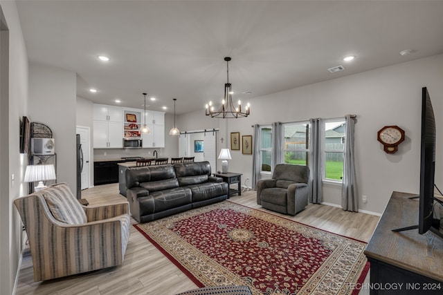 living room with light wood-type flooring and an inviting chandelier