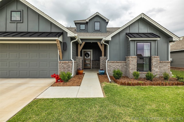 view of front of home with a garage and a front lawn