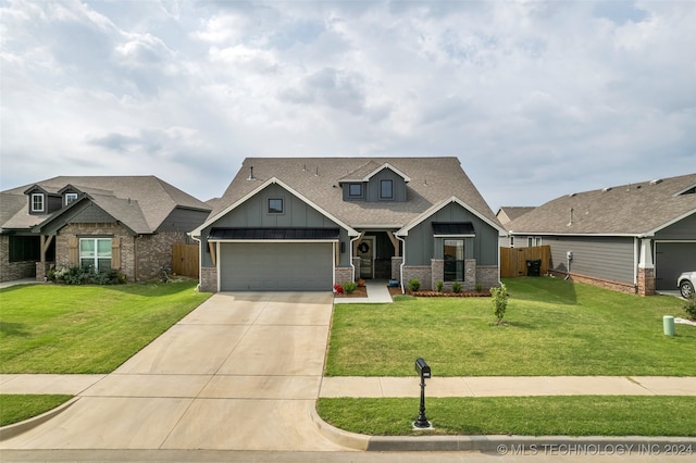 craftsman house with a garage and a front lawn