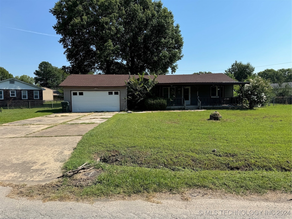 view of front of property featuring a garage and a front lawn