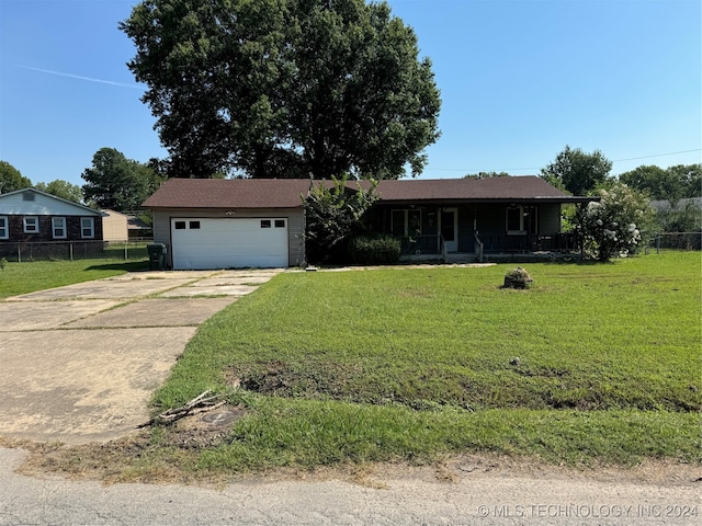 view of front of property featuring a garage and a front lawn