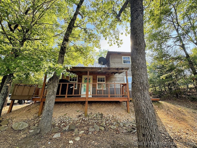 back of house featuring a wooden deck