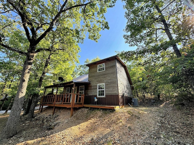 exterior space with cooling unit and a deck