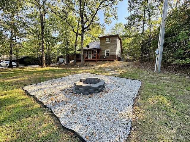 view of yard featuring an outdoor fire pit and a wooden deck