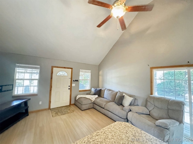 living room with ceiling fan, high vaulted ceiling, and light wood-type flooring