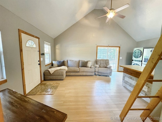 living room featuring light hardwood / wood-style floors, high vaulted ceiling, plenty of natural light, and ceiling fan