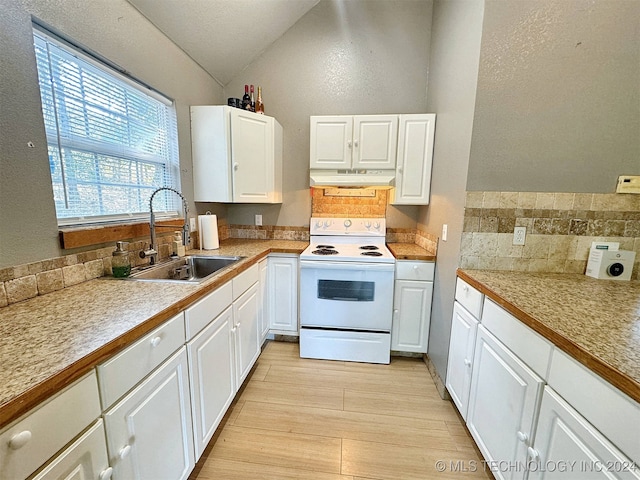 kitchen with decorative backsplash, white cabinets, sink, and electric stove