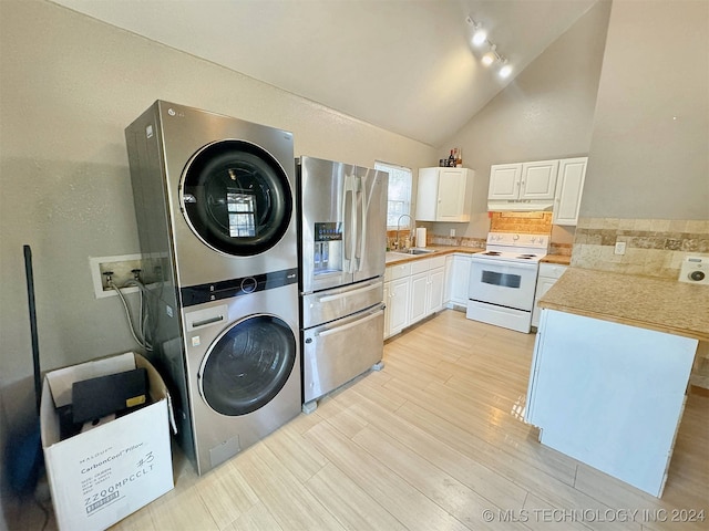 washroom with stacked washer / drying machine, sink, light wood-type flooring, and a high ceiling