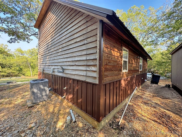 view of side of home featuring central AC