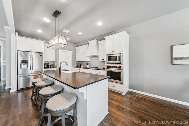 kitchen featuring stainless steel appliances, premium range hood, sink, and white cabinetry