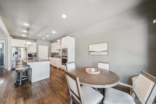 dining space with sink and dark hardwood / wood-style floors