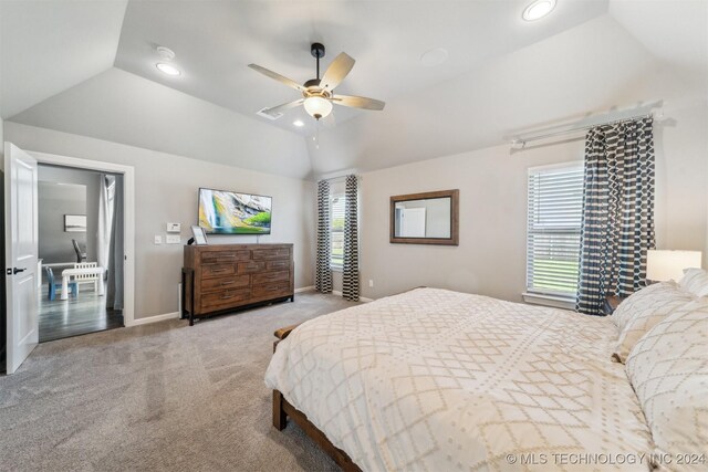 bedroom featuring ceiling fan, vaulted ceiling, and light carpet