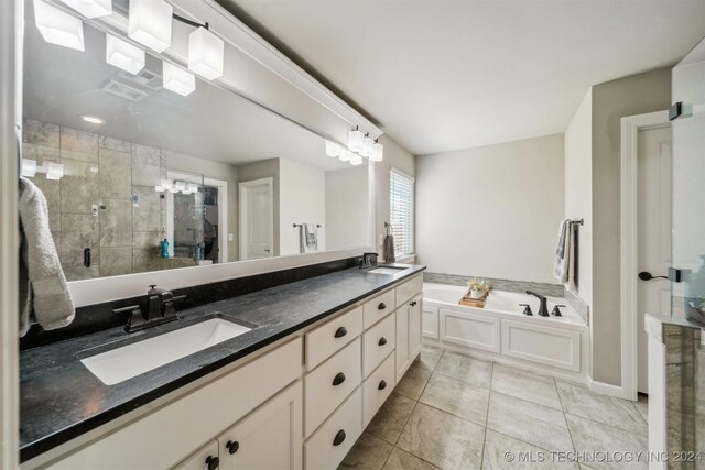 bathroom with tile patterned floors, vanity, and independent shower and bath