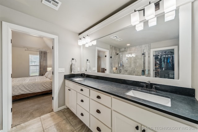 bathroom featuring vanity, a shower with door, and tile patterned flooring