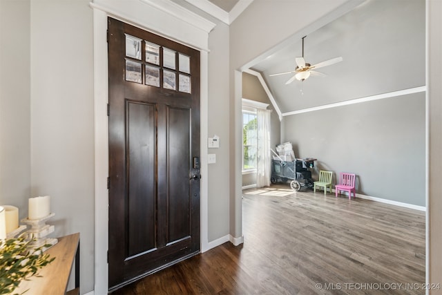 entryway featuring vaulted ceiling, dark hardwood / wood-style floors, crown molding, and ceiling fan