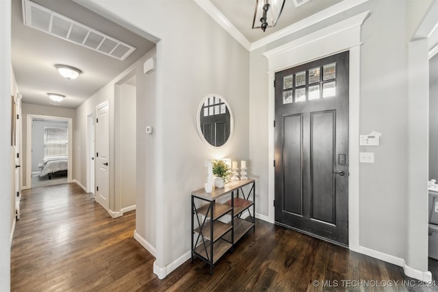 entrance foyer featuring crown molding, plenty of natural light, and dark hardwood / wood-style floors