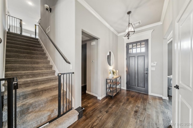 entrance foyer featuring dark hardwood / wood-style flooring and crown molding