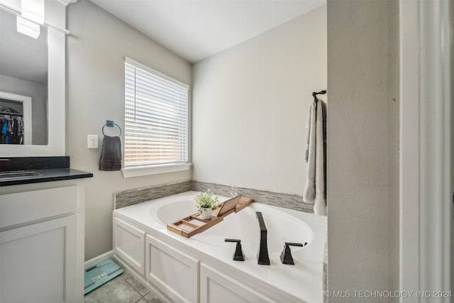 bathroom with vanity, tile patterned floors, and a tub