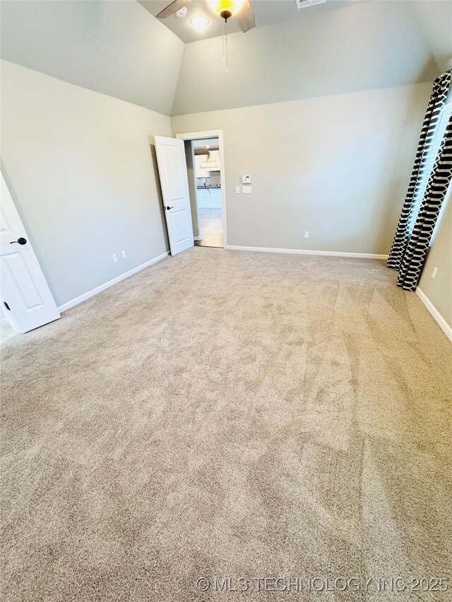 unfurnished bedroom featuring lofted ceiling and carpet floors