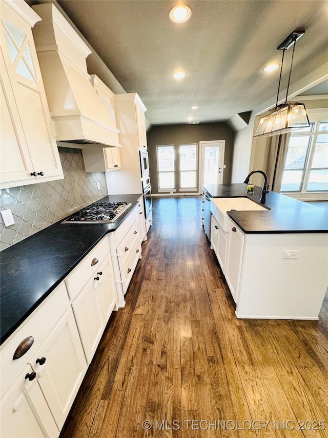 kitchen featuring white cabinetry, appliances with stainless steel finishes, and decorative light fixtures