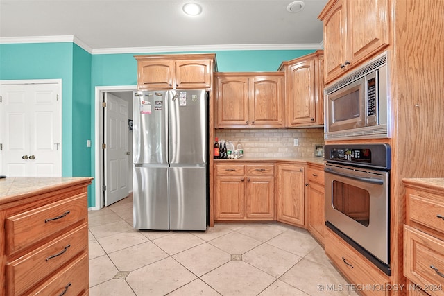 kitchen with light tile patterned flooring, crown molding, stainless steel appliances, and backsplash