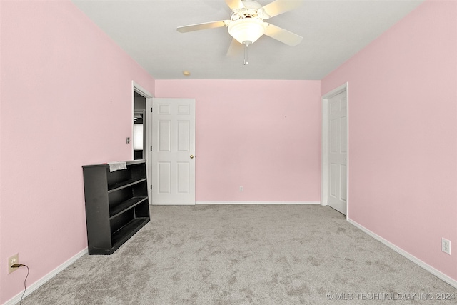 unfurnished bedroom featuring ceiling fan and light carpet