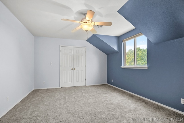 additional living space featuring lofted ceiling, carpet, and ceiling fan