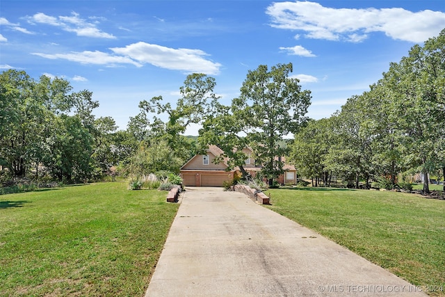 view of front of house with a front yard and a garage