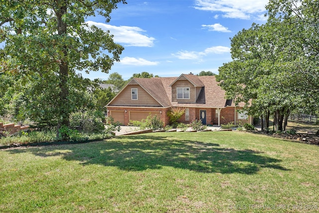 view of front of home with a front yard and a garage