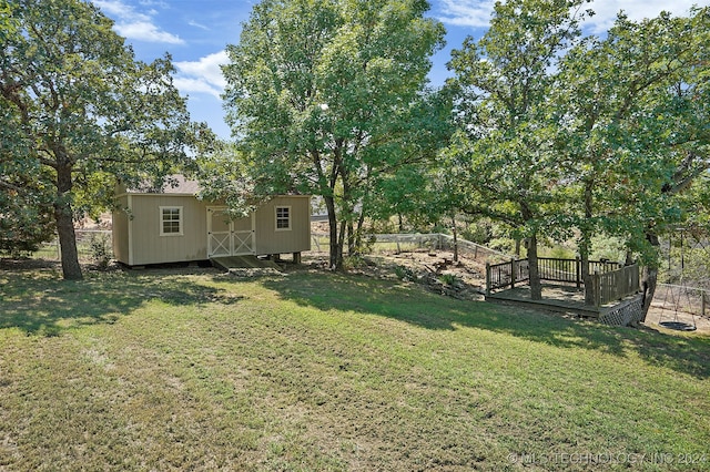 view of yard featuring a deck and a shed