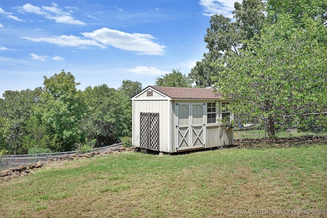 view of outbuilding with a yard