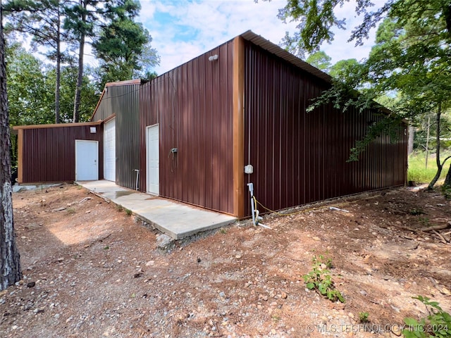 exterior space with an outbuilding and a garage