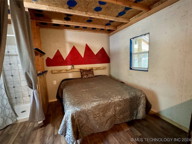 bedroom with dark hardwood / wood-style floors and beamed ceiling