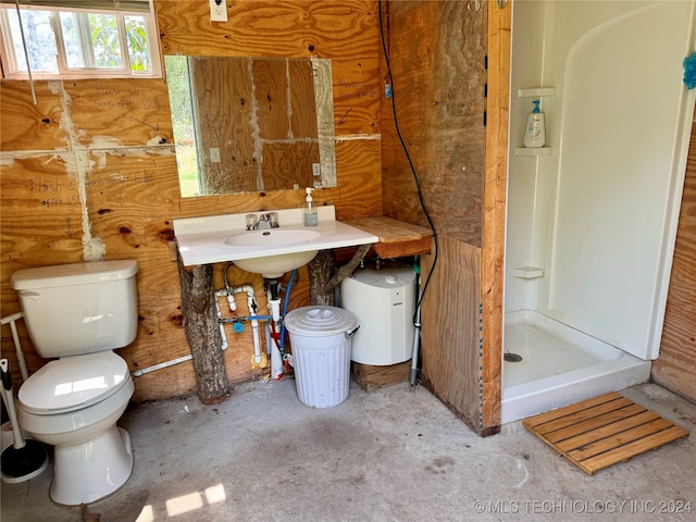 bathroom with toilet, walk in shower, and sink