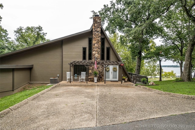 view of side of property featuring cooling unit and a patio area