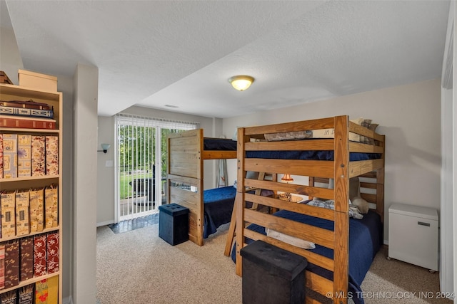 bedroom with light carpet and a textured ceiling